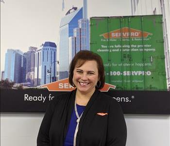 SERVPRO of Middletown shares picture of one of their male project managers smiling and standing in front of a SERVPRO Ad.