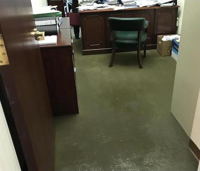 Wet carpeting on the floor of an office. 