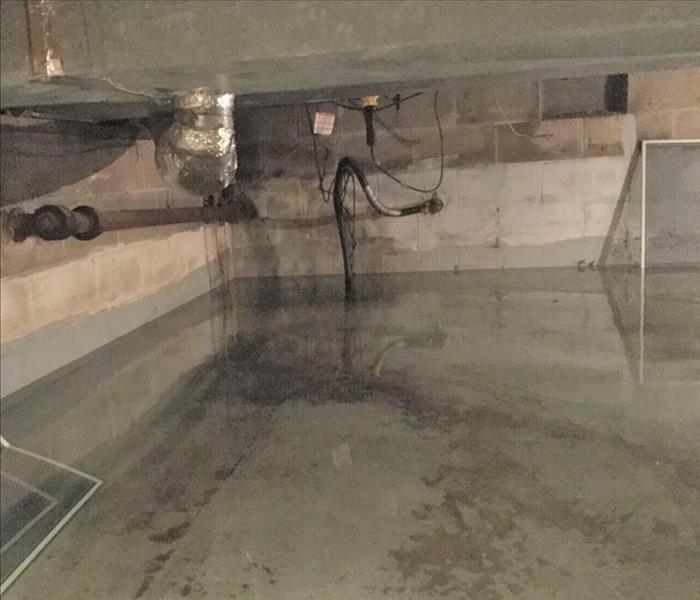 a flooded concrete floor in a basement